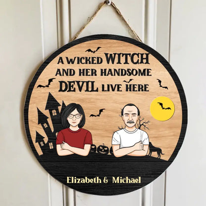 A Wicked Witch And Her Handsome Devil Live Here - Couple Personalized Custom Round Shaped Home Decor Witch Wood Sign - Halloween Gift For Witches, Husband Wife